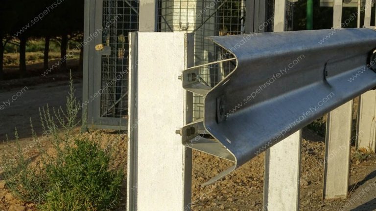 Spacer and bolts joining the W-beam to the post